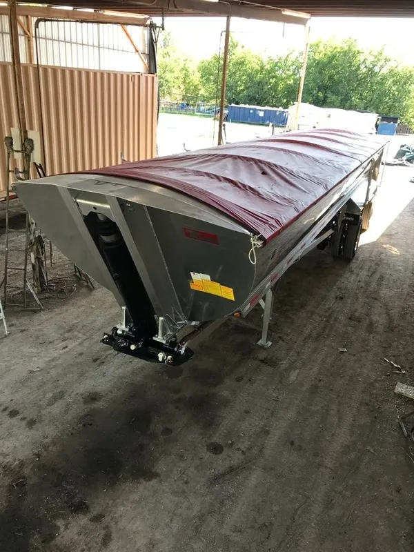 Large industrial conveyor belt system covered with a tarp.
