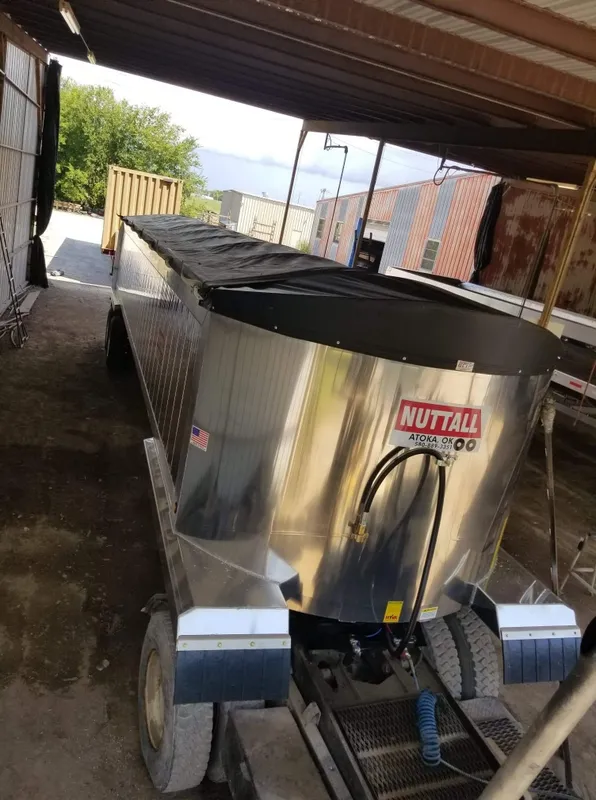 Stainless steel NutriMilk machine under a canopy outdoors.